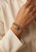 Gold alloy bead bracelet with blue heart charm