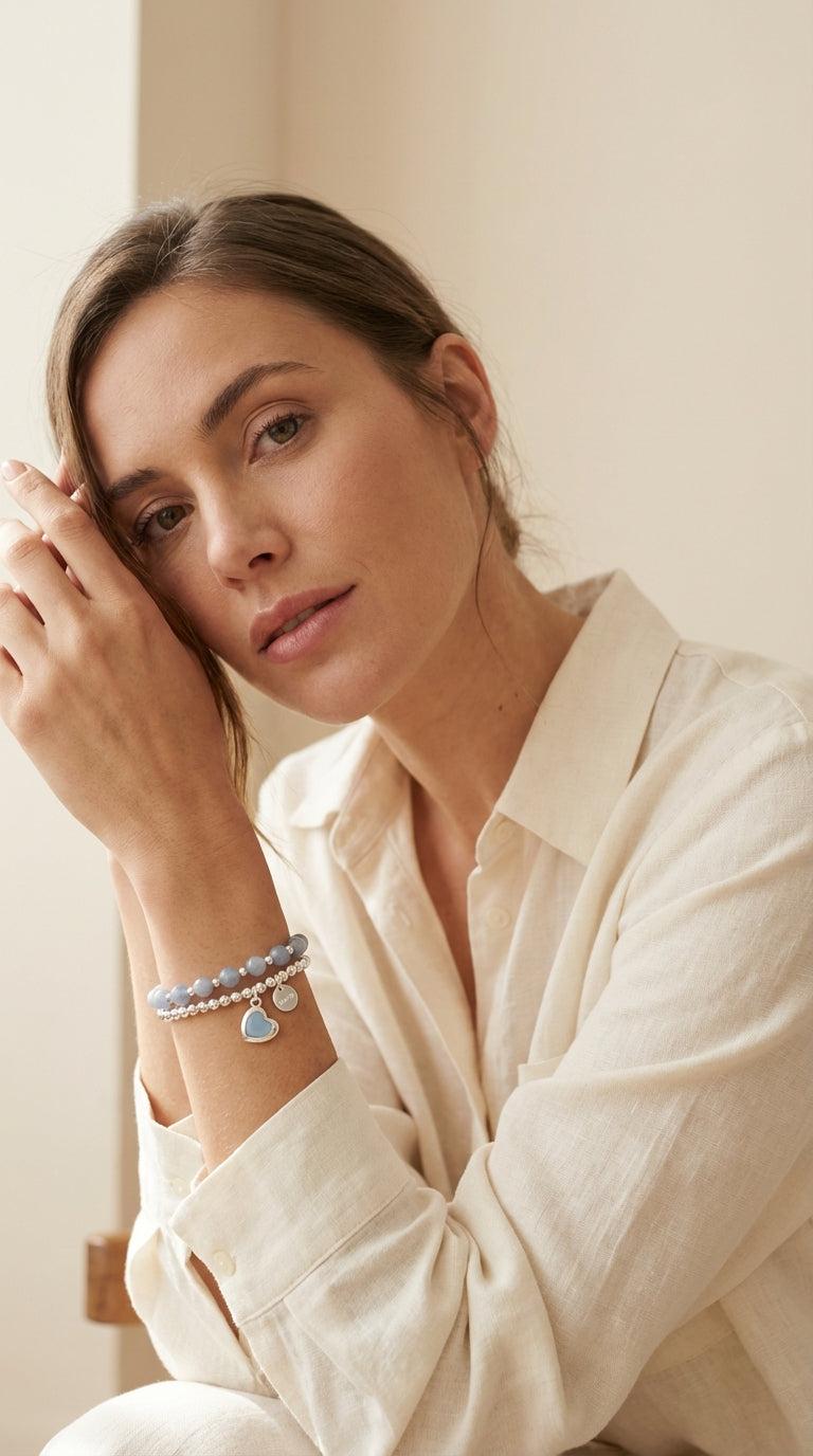 Silver and blue bead stretch bracelet with heart charm