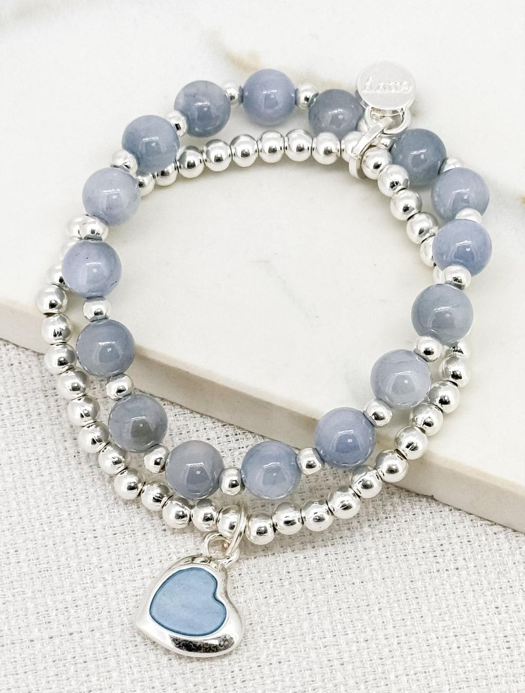 Silver and blue bead stretch bracelet with heart charm